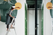 © Milles Studio/Stocksy - Young female painting on wall in new apartment