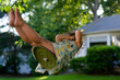 © Lauren Lee/Stocksy - Carefree child on swing in summer
