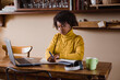 © Mauro Grigollo Photographer/Stocksy - Black woman using laptop during smartworking. Lifestyle images.