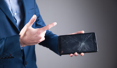 Canvas Print - man holding broken screen tablet