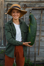 Cheerful Female Farmer With Huge Zucchini