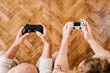 © Alina Hvostikova/Stocksy - Father and son with gamepads playing video game