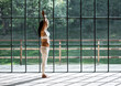 © Milles Studio/Stocksy - Pregnant female doing yoga against huge window