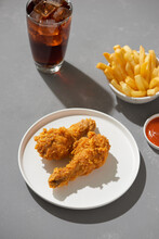 Fried Chicken Nuggets With French Fries,cola And Sauce Isolated On Gray