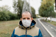 © Alexey Klementiev/Stocksy - Senior man wearing disposable mask on the street