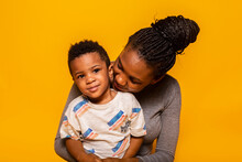 Black Mother And Son Looking At Camera