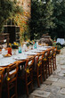 © Melissa Milis Photography/Stocksy - Long table outdoors for Italian wedding dinner