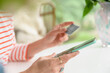 © jamie grill photography/Stocksy - Woman holding a credit card and smartphone