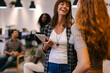 © MyMicrostock/Stocksy - Two businesswomen talking in an office