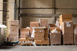 © Jelena Jojic Tomic/Stocksy - A small warehouse packed with a carload ready for distribution