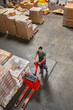 © Jelena Jojic Tomic/Stocksy - One man operates the pallet jack in a warehouse full of shipping goods