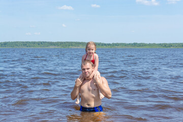 People frolic in the water on a hot, sunny summer day.