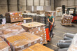 © Jelena Jojic Tomic/Stocksy - One man operates the pallet jack in a warehouse full of shipping goods