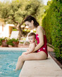 © Guille Faingold/Stocksy - Mother and a son by swimming pool.