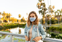 Masked Girl In Front Of Palm Trees In Echo Park.