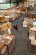 © Jelena Jojic Tomic/Stocksy - One man operates the pallet jack in a warehouse full of shipping goods