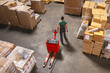 © Jelena Jojic Tomic/Stocksy - One man operates the pallet jack in a warehouse full of shipping goods