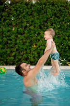 Dad Playing With Son In Pool.