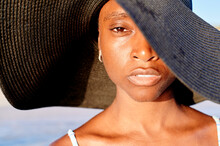 Young Woman Wearing A Sun Hat By The Ocean