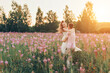 © aaalll3110 - a couple in love walks through a flower meadow. Love and spring blooming. a man embraces a woman