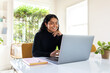 © McKinsey Jordan/Stocksy - Female Entrepreneurs Smiles While Typing On Her Laptop