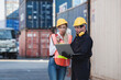© nikomsolftwaer - working engineer in the construction container yard.  worker and supervisor checking containers data. Container Shipping Logistics Engineering concept
