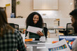 © MyMicrostock/Stocksy - Businesswoman working in an office