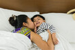 © Chalit Saphaphak/Stocksy - Asian kid on the bed