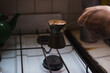 © Ana Luz Crespi/Stocksy - Man holding hot coffee pot