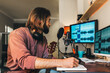 © MyMicrostock/Stocksy - Young man recording music at home music studio