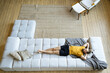 © Ivan Ozerov/Stocksy - Man resting on sofa at home
