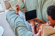 © Ivan Gener/Stocksy - Man working on a laptop on his sofa