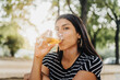 © Tadeu Dreyer/Stocksy - Woman drinking beer