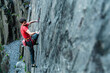 © Manu Prats/Stocksy - Climber grabbing a small ledge in quarry wall
