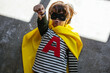 © BONNINSTUDIO/Stocksy - Funny superhero lying on floor