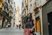 Woman Wearing A Mask And Carrying A Camera