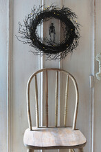 Old Chair With Black Branch Wreath