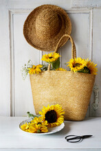 Sunflowers In Straw Purse On Table