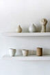 © Dreamwood Photography/Stocksy - Set of ceramic pots and cups on shelf