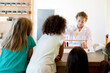 © Jennifer Bogle/Stocksy - Boy doing science demonstration