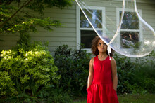 Girl Stares Up At Enormous Bubble