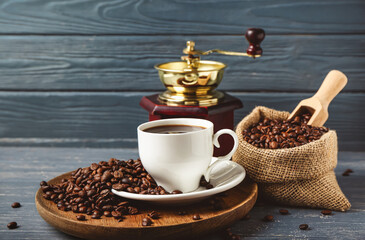 Composition with cup of hot coffee on dark wooden background