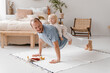 © Alina Hvostikova/Stocksy - Man doing exercises with cute child at home
