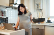 © MaaHoo Studio/Stocksy - Pregnant woman cooking at home