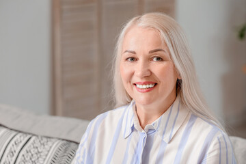 Canvas Print - Portrait of smiling mature woman at home