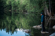 © Jarusha Brown Photography/Stocksy - Man in blue jacket admires the calm surface of a lake.