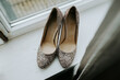 © Melissa Milis Photography/Stocksy - Glitter high heels in front of a window
