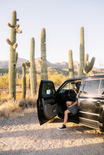 Woman Sitting In Car In Desert