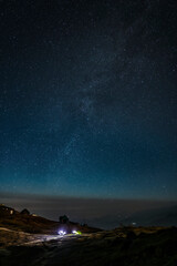 illuminated tent in the night under the sky with many stars