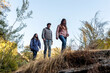 © Bisual Studio/Stocksy - Three friends Walking through the mountain in autumn